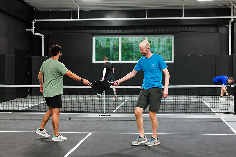Friends playing pickleball at TOPCOURT in Lee's Summit at a private event